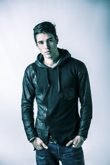Handsome young man in black hoodie sweater, studio shot