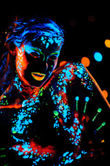 Girl with neon paint bodyart portrait, studio shot