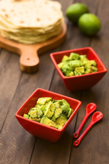 Avocado salad prepared with lime juice, pepper, salt and garnished with fresh coriander leaves (Selective Focus, Focus in the middle of the salad)