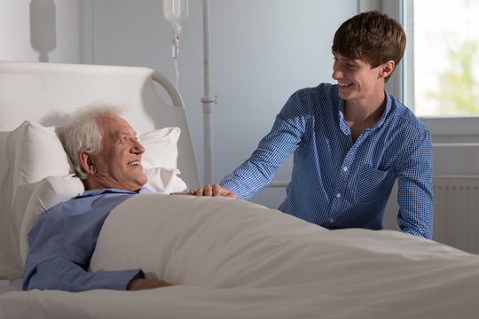 Grandson visiting grandpa in hospital