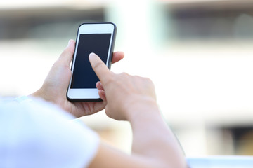 young woman hands use smart phone in city