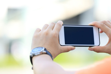closeup of young woman hands use smart phone in city