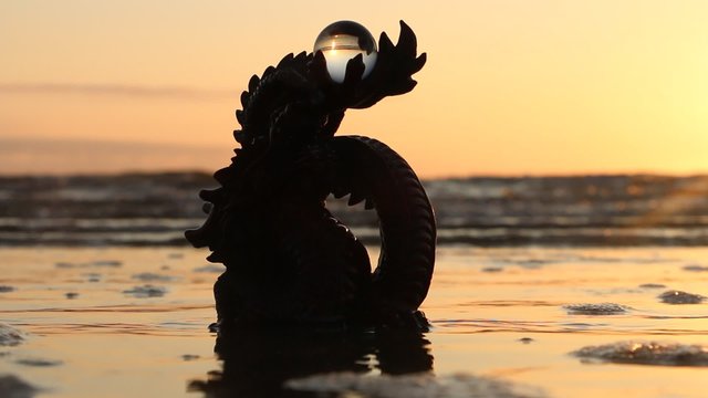 Dragon with pearl, sunset