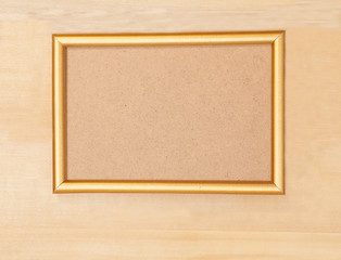 Fototapeta premium Empty golden picture frame on wooden background