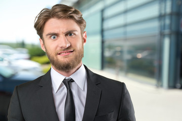 Shocked businessman with funny facial expression