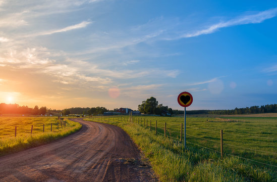 Rural Road Beautiful Sunset Road Signs Which Shows The Heart.