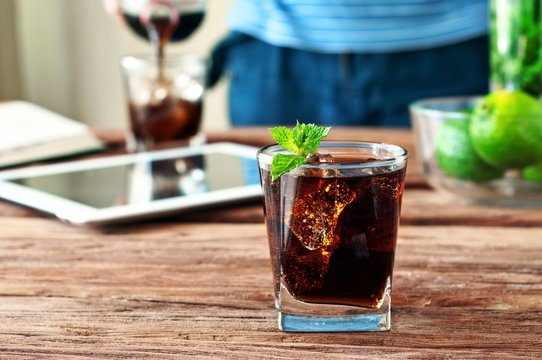 glass of cola with ice and mint