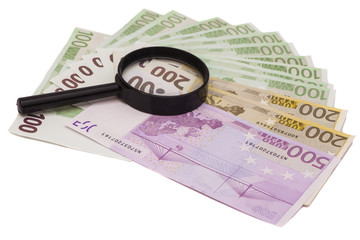 Euro banknote under magnifying glass