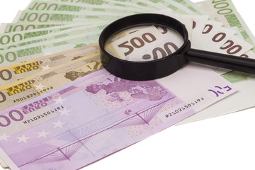 Euro banknote under magnifying glass
