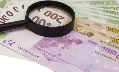 Euro banknote under magnifying glass
