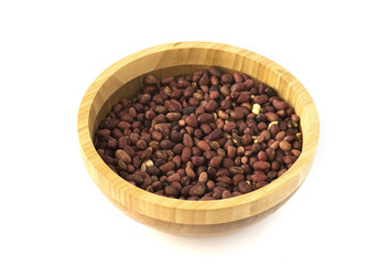 Wooden plate with roasted peanuts