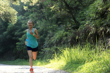 Runner athlete running on forest trail.  