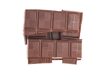 Broken milk chocolate bar isolated on white background