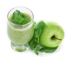 Glass of green healthy juice with basil and apple isolated on white