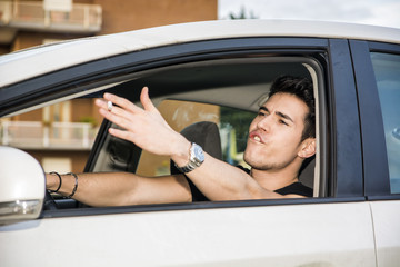 Angry Young Man Driving a Car and Yelling at Someone