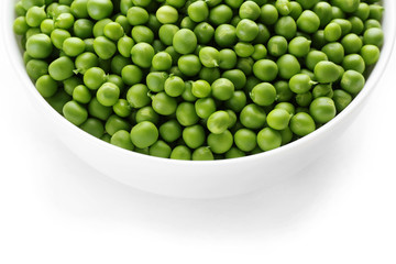 Fresh green peas in bowl close up