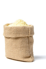 uncooked corn flour in sack on the white, (large depth of field, taken with tilt shift lens)
