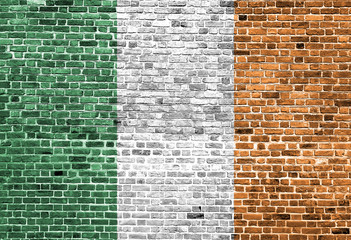 Flag of Ireland painted on brick wall, background texture
