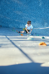 Little boy in  rock climbing gym
