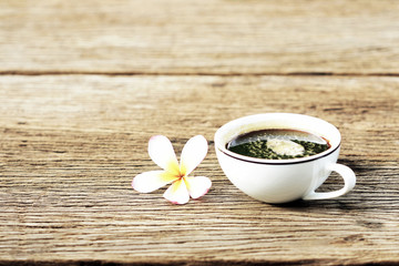 black coffee in white cup on wooden table