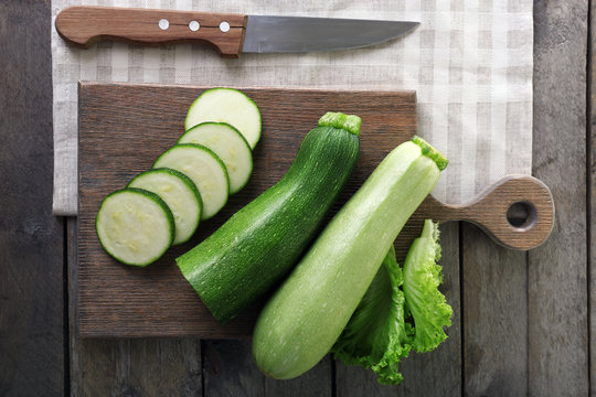 Fresh zucchini with squash on cutting board