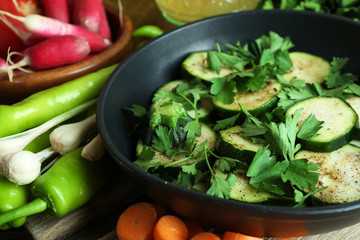 Sliced zucchini in pan on table, closeup