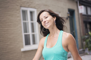 Portrait of attractive woman in urban background wearing casual clothes