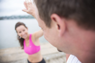 Fototapeta premium Sport woman and man jogging on road outside.