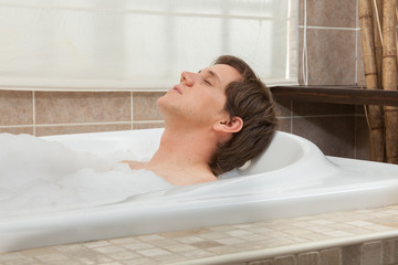 Naklejka premium Man relaxed in the tub