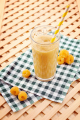 Raspberry smoothie with berries on table close up