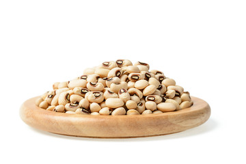 raw black eyed peas in the wooden plate, (large depth of field, taken with tilt shift lens)