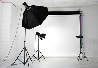 Empty photo studio with lighting equipment