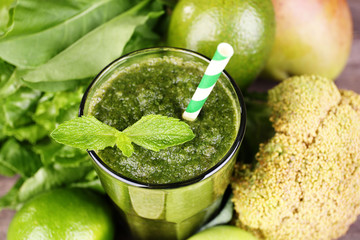 Green healthy juice with fruits and vegetables close up