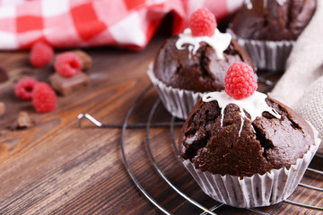 Delicious cupcakes with berries on table close up