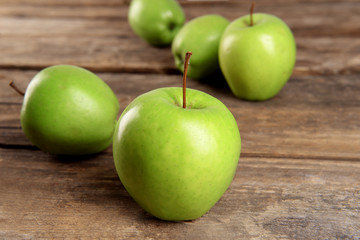 Ripe green apples on wooden table close up