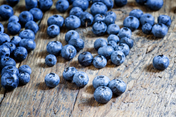 Fresh blueberries on old wooden background selective focus
