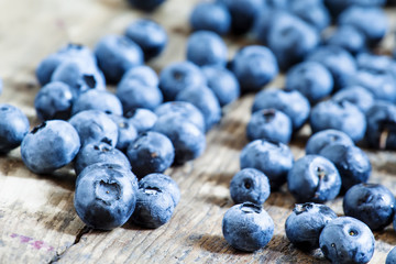 Fresh blueberries on old wooden background selective focus