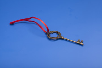 Key To Success With Red Bow isolated on blue background