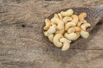 Roasted cashews on natural wooden background