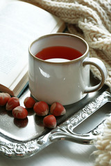 Cup of tea with book on metal tray, closeup