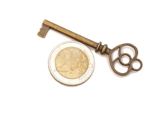 Key to success and euro coin isolated on white