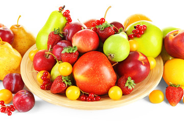 Naklejka na ściany i meble Heap of fresh fruits and berries on plate close up
