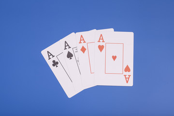 Four aces isolated on blue background