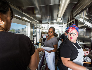Preparing Food on Busy Food Truck