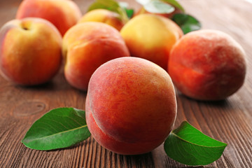 Fresh peaches on wooden table, closeup