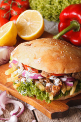 Doner kebab with meat and vegetables closeup. Vertical
