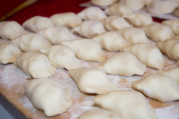 Fototapeta na wymiar Varenyky/Ukrainian dumplings, Ukrainian vareniks mold kitchen