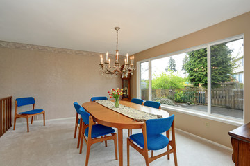 Modern dinning room with royal blue chairs.