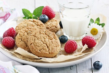 Oatmeal cookies with milk and fresh berries.Selective focus
