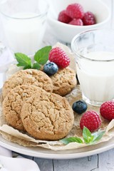 Oatmeal cookies with milk and fresh berries.Selective focus
